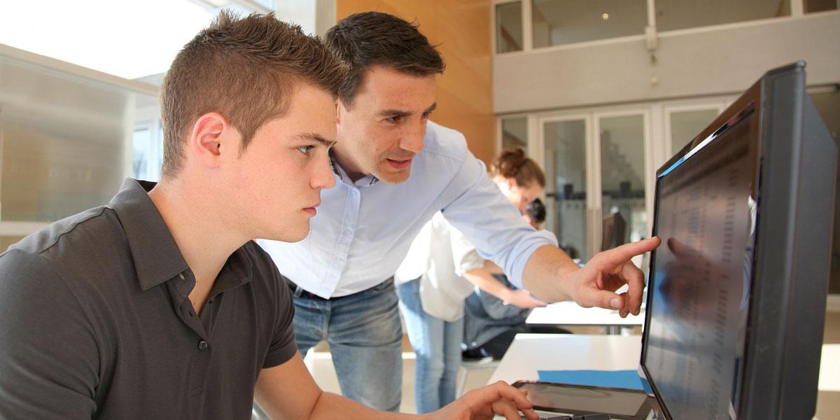 Instructor and student using a computer.